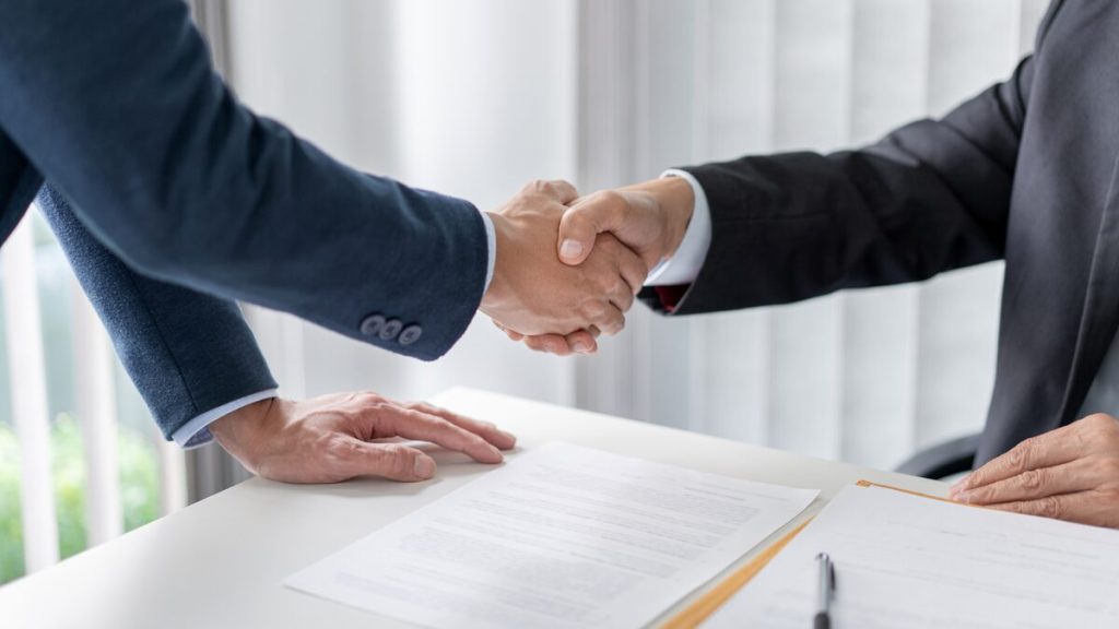 Solicitor and client shaking hands after signing an agreement at Fitz Solicitors in Datchet